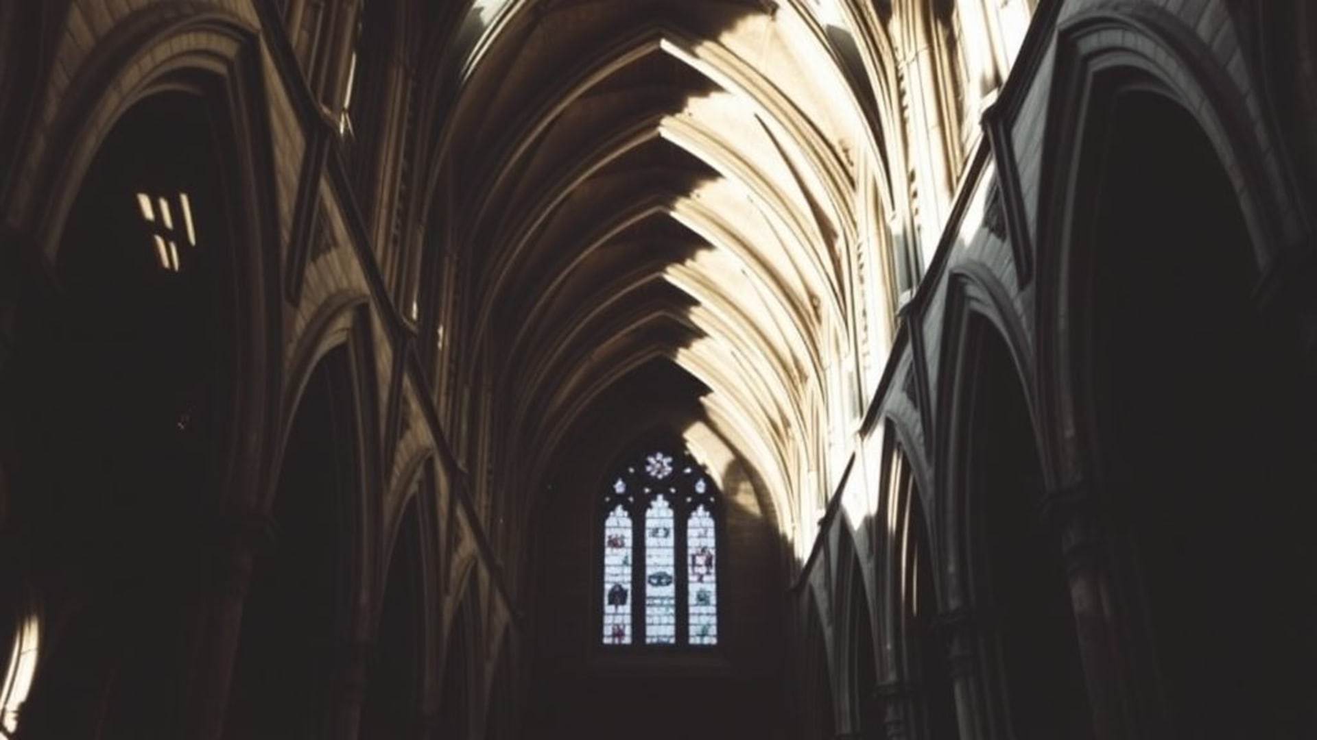 gothic cathedral architectural geometry stone arches moody wallpaper dramatic shadows vaults