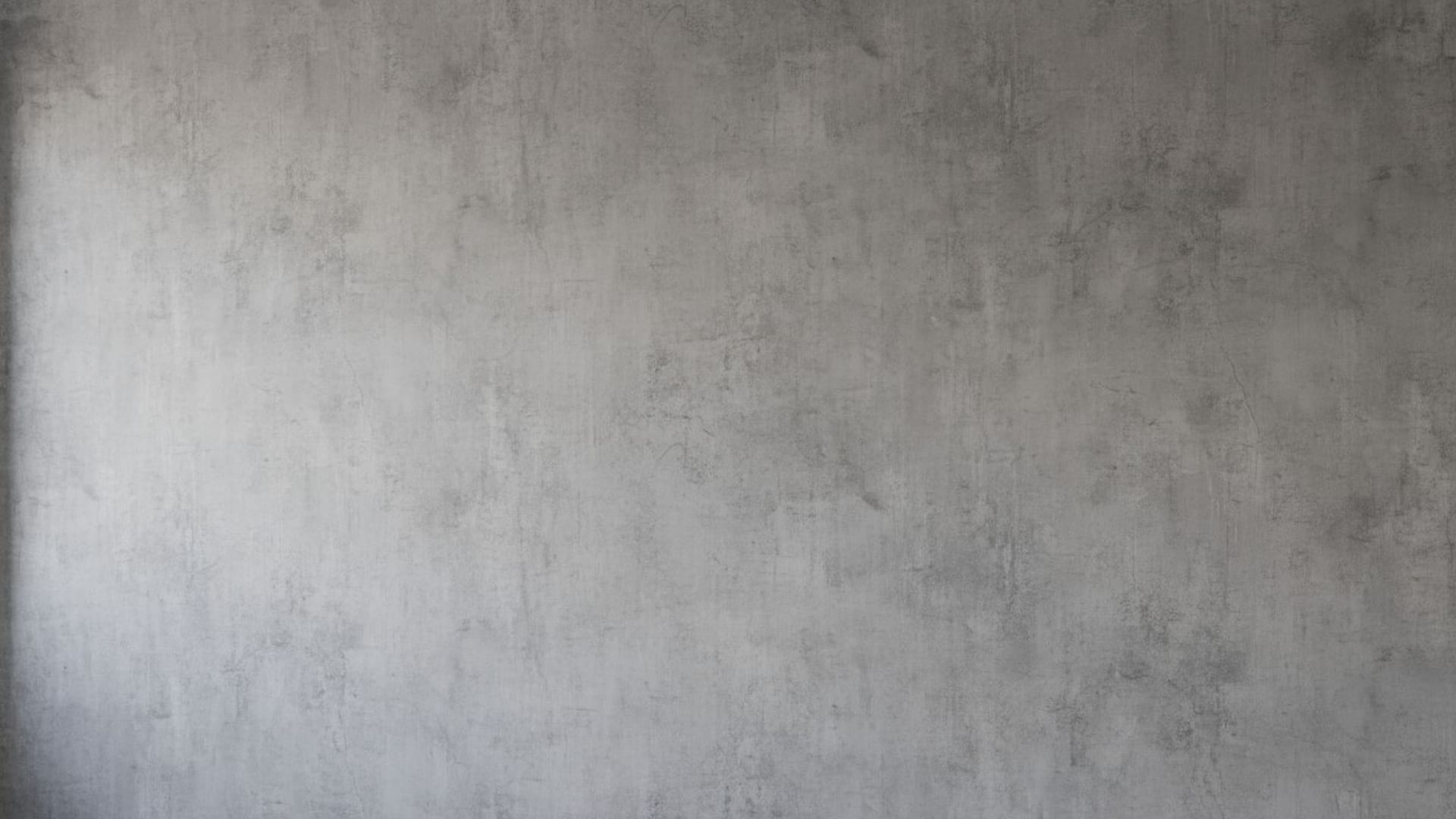 Mur en béton texturé en style industriel, fond ecran gris atténué, minimaliste, moderne, urbain